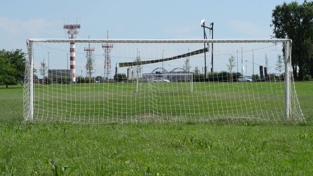 Porte di calcio e sullo sfondo l'aeroporto di Milano Linate
