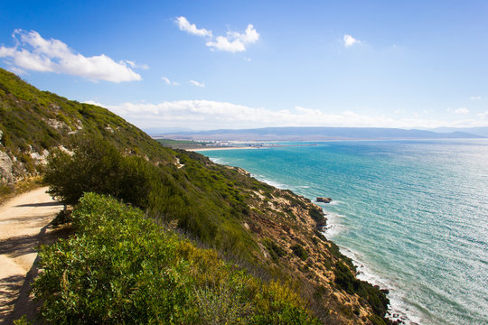 Nature park path with Barbate town on the background in sunny Andalusia, South Spain. Popular landmark in Cadiz province