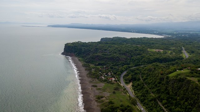 Beautiful aerial view of the beach with parapenting in the horizon