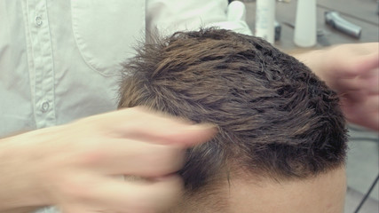 Naklejka premium Man at the hairdresser, she has finished the cut