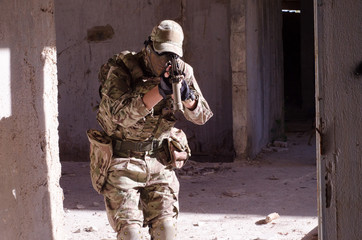 Airsoft soldier inside building Airsoft soldier inside building hold on hands rifle aim camera
