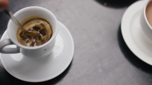 Close up of cup of espresso being stirred
