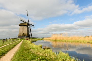 Windmill on canal in West Friesland, Netherlands