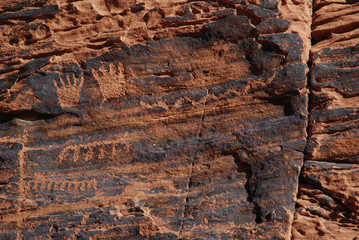 Hands petroglyphs on red sandstone