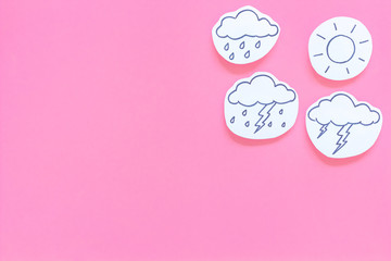 Weather forecast concept. Modern weather icons set on pink background top view copy space