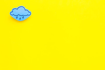 Rainfall forecast concept. Weather icons. Rainy cloud on yellow background top view copy space