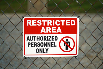 close up on restricted area sign on the iron fence
