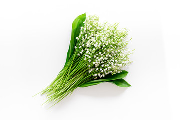 May flowers. Bouqet of lily of the valley flowers on white background top view copy space
