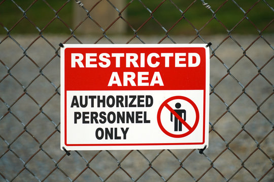 close up on restricted area sign on the iron fence