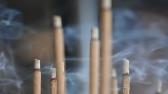 slow motion close up of incense smoke at kinkakuji temple in kyoto, japan- originally recorded at 180p