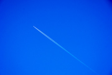 Single aeroplane across blue sky