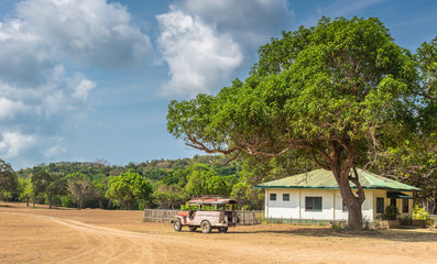 Busuanga Coron, Philippines - March 27, 2018: View of philippino house and old jeep car under the big tree at  Calauit Island, Busuanga, Palawan, Philippines
