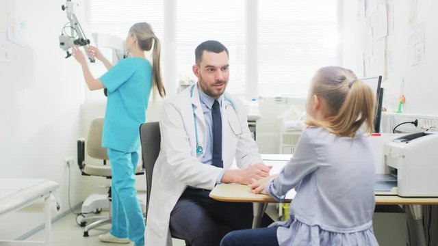 Little Girl Visits Doctor's Office. Friendly Pediartrist Talks with Smart Little Girl. Child Health Examination.  Shot on RED EPIC-W 8K Helium Cinema Camera.