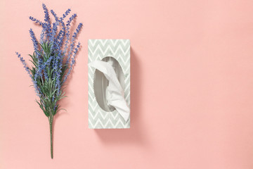 Tissue box and blue lavender on pink background - obrazy, fototapety, plakaty