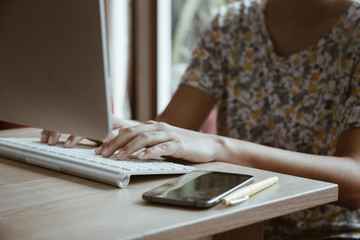 working day in office,workplace table and office desk close up hand on keyboard