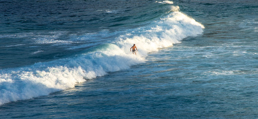 Man Surfer riding on his surfboard on the waves in summer - Extreme sport concept 