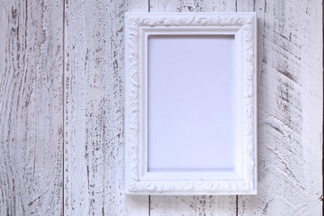 empty vintage white frame on white  shabby chic background.empty interior frame.Vintage frame mockup.Minimalist framed art