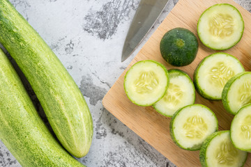 Fresh cucumber slices on a cutting board. Top view