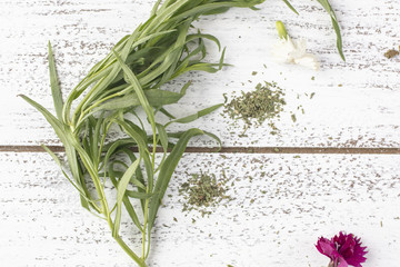 Tarragon,herb on a rustic table top with edible flowers