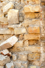 Destroyed piece of the wall, texture of old brick. Construction background.