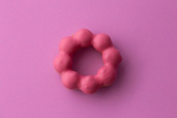 Close up flat lay of pink pon de ring isolated on pink background