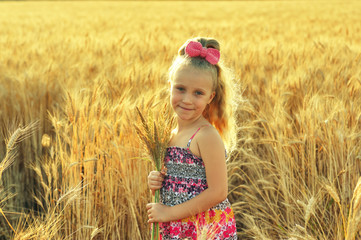 Portrait of a little girl in a wheat field