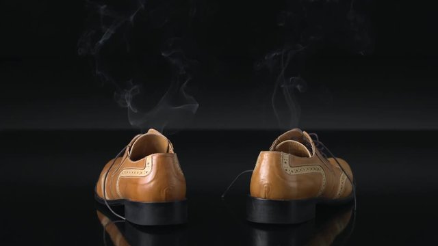 A pair of dress shoes steaming after a hot day of wear. Can also be used to infer someone has disappeared or vanished from boots.