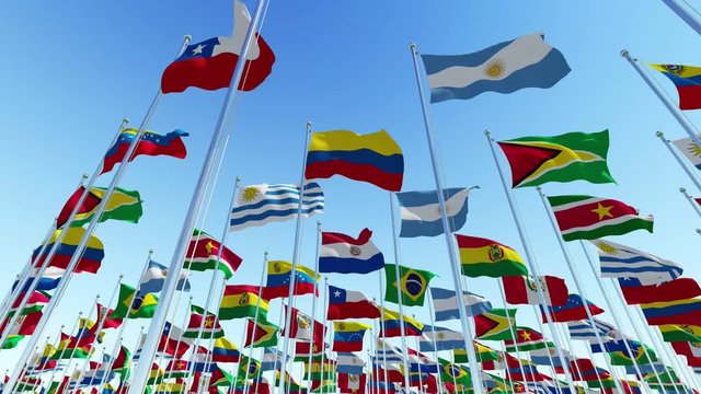 Many flags of the countries of the South American continent waving in the wind against clear blue sky, 3d rendering animation