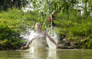 boy jumping into the water .