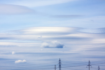 Amazing clouds in the blue sky and electric wires