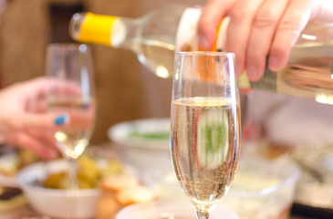 Woman hand holding a wine glass and speaking the toast. Congratulatory speech.