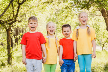 happy fun kids in colorful t-shirts outdoors