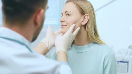 Plastic / Cosmetic Surgeon Examines Beautiful Woman's Face, Touches it with Gloved Hands, Inspecting Wrinkles for Future Facelift Surgery. Shot on RED EPIC-W 8K Helium Cinema Camera.