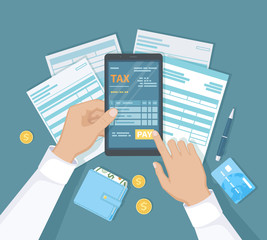 Internet Payment of taxes, invoice, bill, banking. Man hand holding the phone and presses the pay button. Online Paying, Financial accounting. Documents, forms, money, wallet, credit card on the table