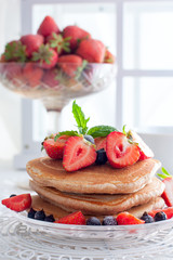 Breakfast with pankakes from whole wheat flour and fresh berries, selective focus