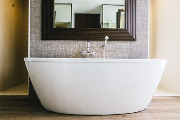 White bathtub decoration in bathroom interior