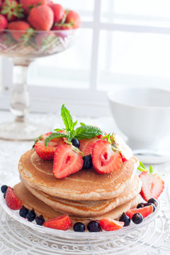 Breakfast with pankakes from whole wheat flour and fresh berries, selective focus