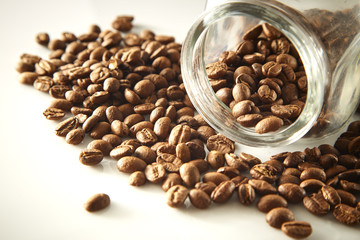 roasted coffee beans poured from clear glass