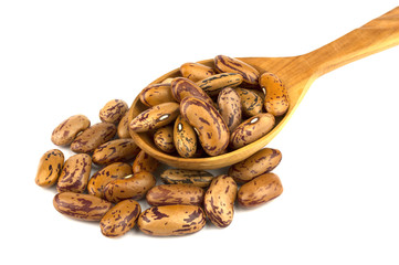 Haricot beans in a wooden spoon  isolated on white background