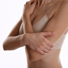 Mid section view of woman touching elbow feeling pain