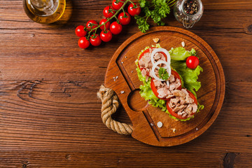 Delicious tuna sandwich, served with lettuce, tomato and onion.