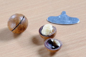 Macadamia nuts in shell on wooden table