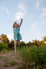 Fototapeta premium The girl runs joyfully with her hands up