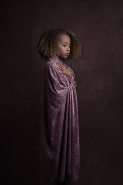Studio portrait of girl in purple bathrobe