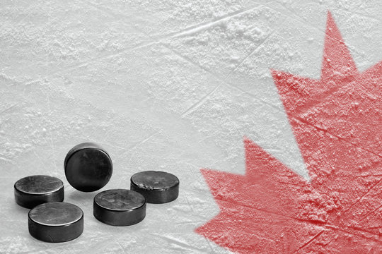 Canadian maple leaf image on ice with hockey puck
