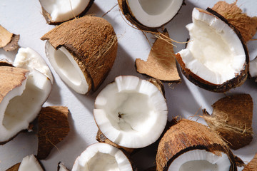 Close up image of cracked coconut on gray background