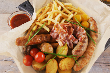 Snack with sausages, bacon and potatoes