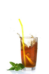 Splashes from a glass of cold tea with lemon.
