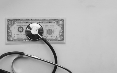 stethoscope on a hundred dollars banknote