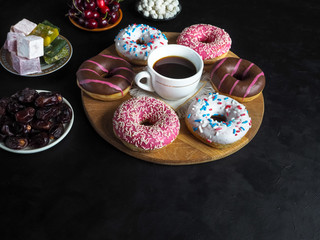 Donut sweets and Turkish sweets on a black table with copy space